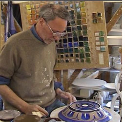 Jonathon Chiswell Jones decorating a lustreware bowl